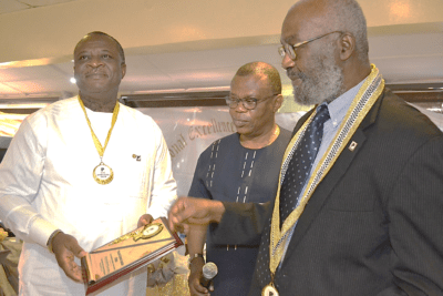 L-R: Pharm. Ike Ugwu, chief executive officer, Pharmacare Support Group receiving a Fellowship award plaque from Sir Ifeanyi Atueyi, PEFON Board of Trustees member while Engr. Ibikunle Oguntayo, representative of Prince Juli Adelusi-Adeluyi, looks on